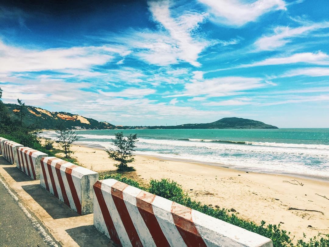 Hon Rom Beach's pristine white sand stretching beneath the mountain 